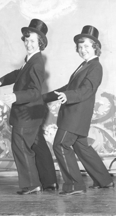 Two women dancing in mens suits